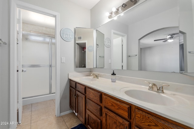 bathroom with vanity, ceiling fan, walk in shower, and tile patterned flooring