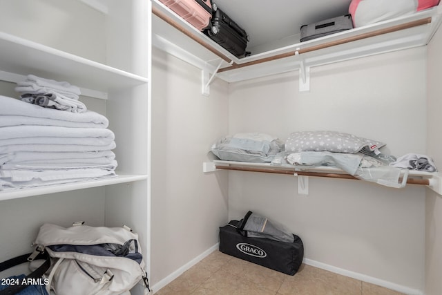 spacious closet with light tile patterned flooring