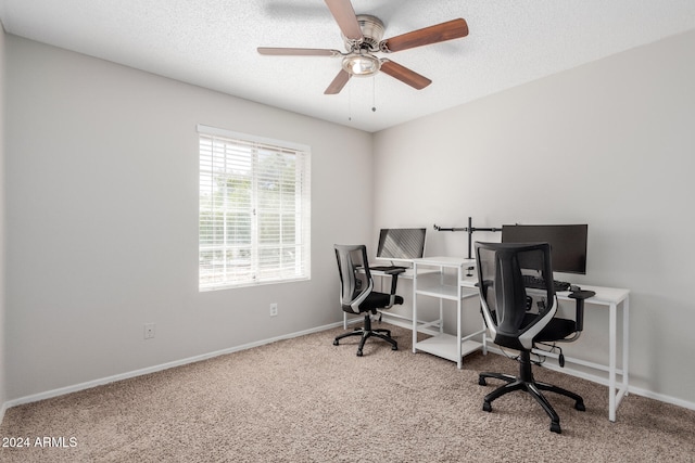 office featuring a textured ceiling, carpet flooring, and ceiling fan