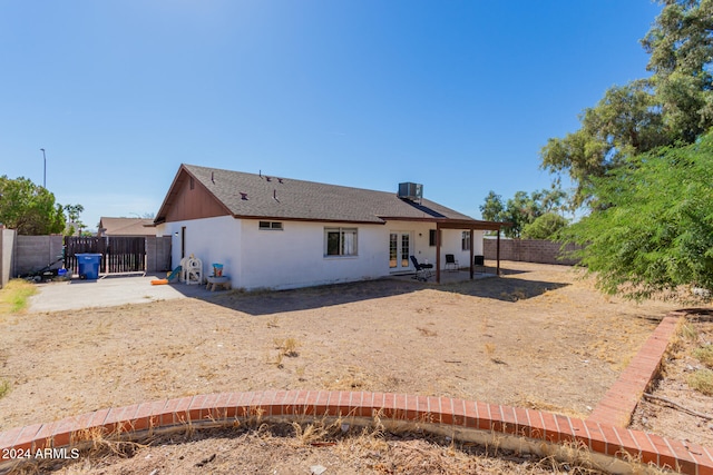 rear view of property with central air condition unit and a patio