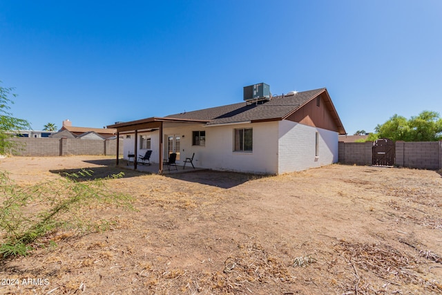 rear view of house with a patio and central AC unit