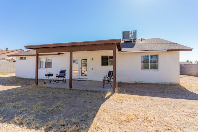 rear view of house with a patio and central AC