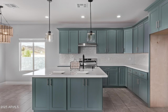 1724 N Main Dr, Apache Junction, AZ 85120 - kitchen with electric range, light countertops, backsplash, under cabinet range hood, and pendant lighting