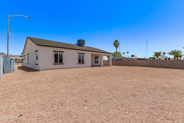 1724 N Main Dr, Apache Junction, AZ 85120 - back of property featuring a fenced backyard, stucco siding, and central AC unit