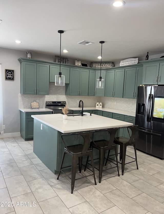 1724 N Main Dr, Apache Junction, AZ 85120 - kitchen featuring fridge with ice dispenser, stainless steel electric stove, green cabinetry, light countertops, and backsplash