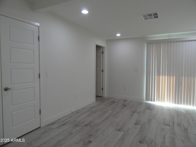 unfurnished room with wood finished floors, recessed lighting, and baseboards