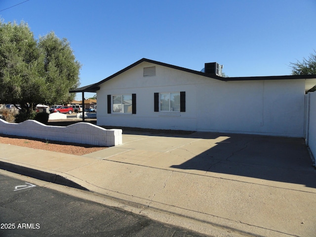 view of side of property featuring fence and cooling unit