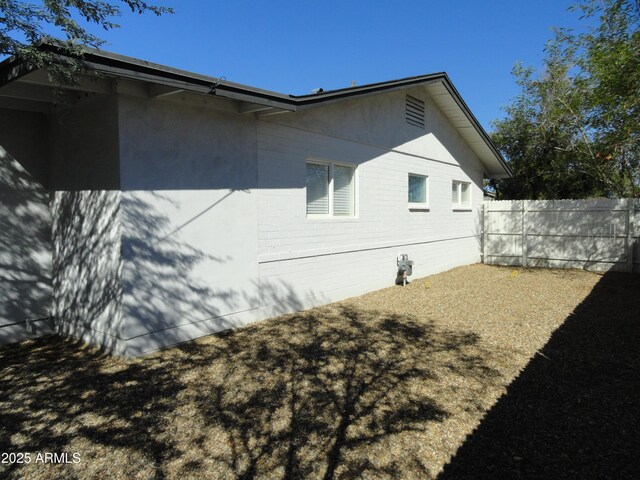 view of property exterior with fence