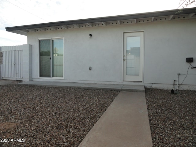 rear view of property with stucco siding