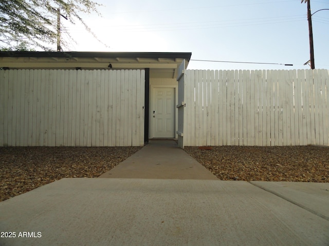 view of outbuilding featuring fence