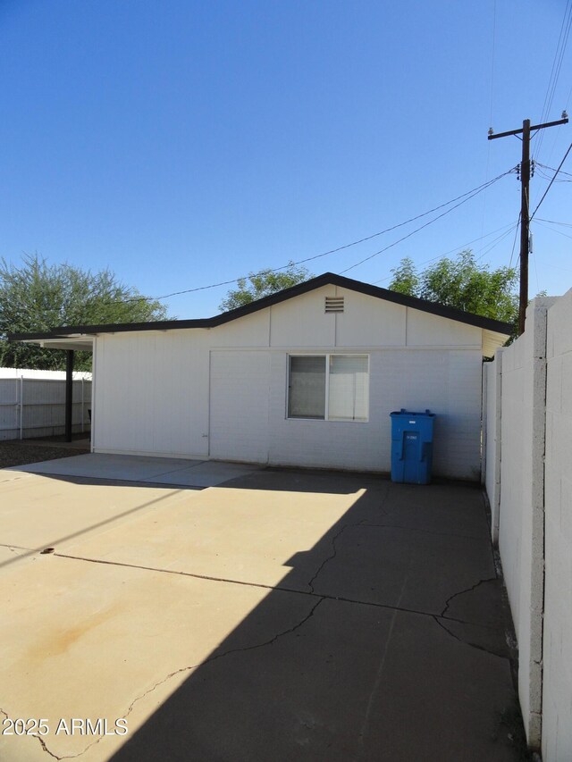 back of house with fence and a patio
