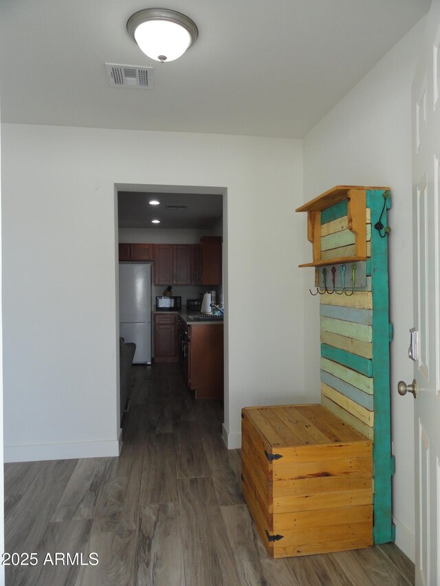 hallway with baseboards and dark wood-style floors