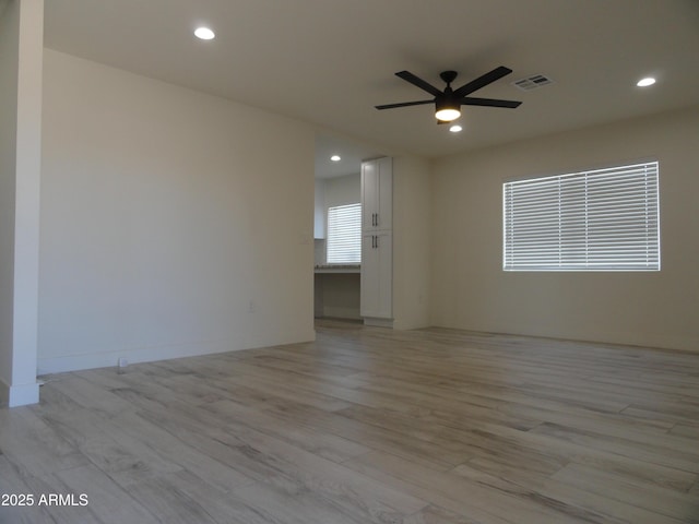 empty room with a ceiling fan, light wood-style flooring, and recessed lighting