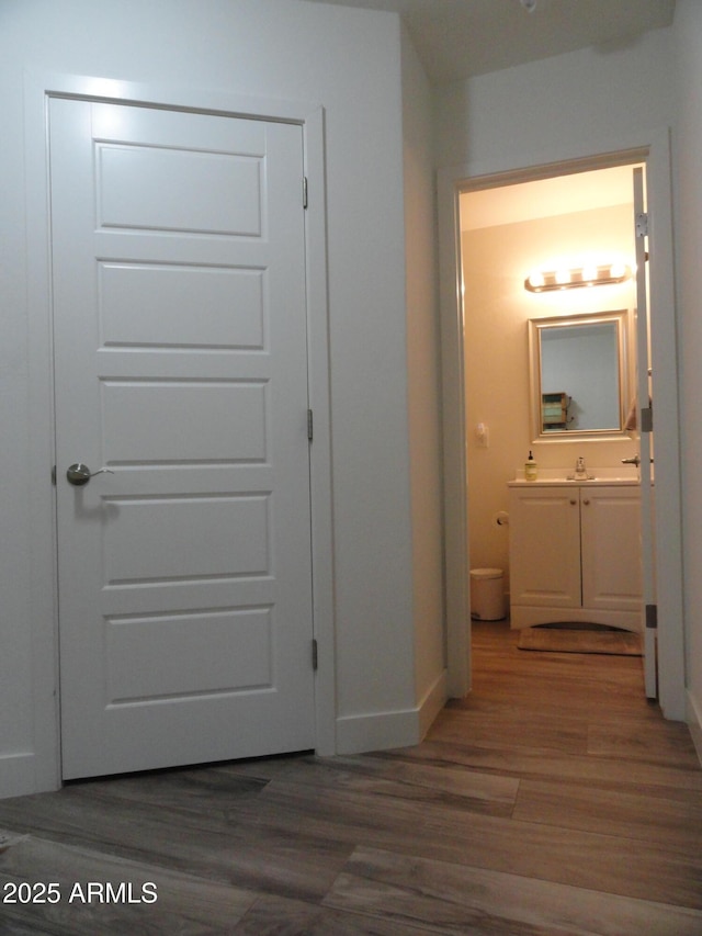 hall with wood finished floors and baseboards