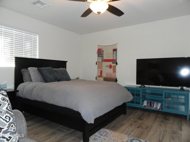 bedroom with wood finished floors and ceiling fan
