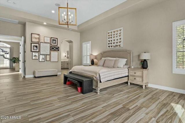 bedroom with an inviting chandelier and ensuite bathroom