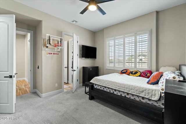 bedroom featuring light carpet and ceiling fan