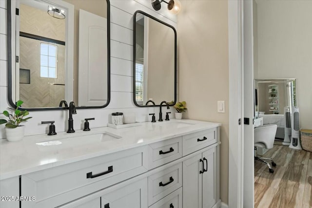 bathroom with hardwood / wood-style floors and vanity