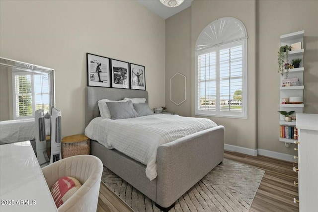 bedroom featuring hardwood / wood-style floors and multiple windows