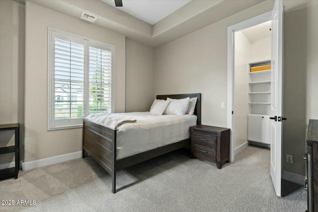 carpeted bedroom featuring ceiling fan and multiple windows