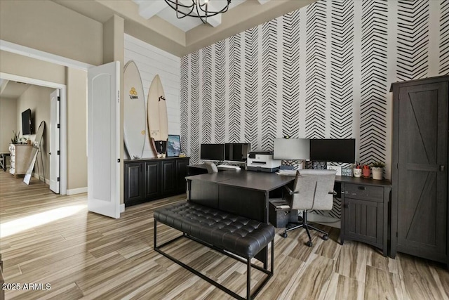 office space featuring light wood-type flooring and an inviting chandelier