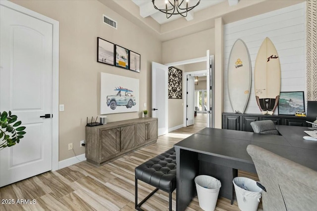 office area featuring light hardwood / wood-style floors and a chandelier