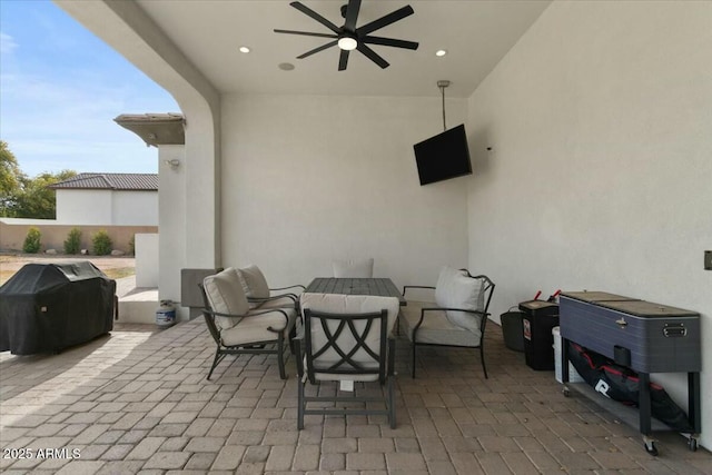 view of patio with ceiling fan and grilling area