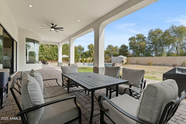 view of patio / terrace with ceiling fan, a pool, and area for grilling