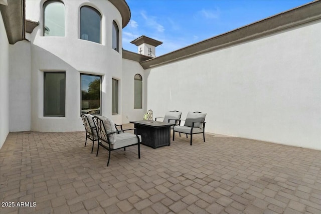 view of patio featuring an outdoor living space with a fire pit