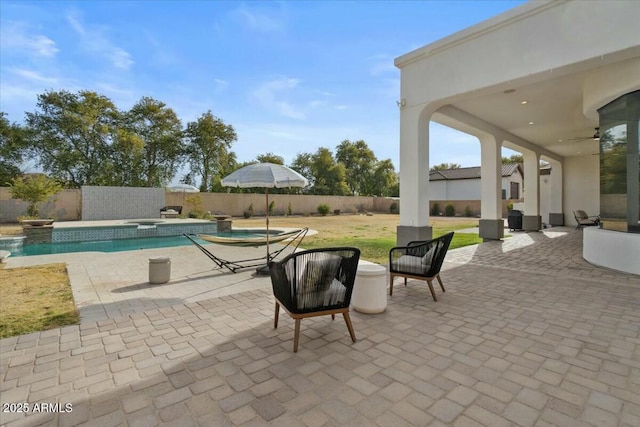 exterior space featuring a swimming pool with hot tub and ceiling fan