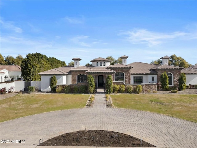 mediterranean / spanish-style home featuring a front lawn