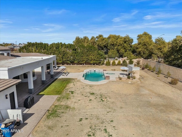 view of pool with an in ground hot tub and a patio