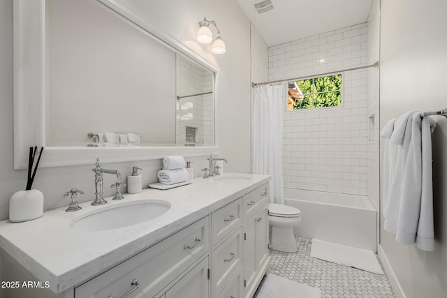 full bathroom featuring tile patterned flooring, vanity, shower / bath combo with shower curtain, and toilet