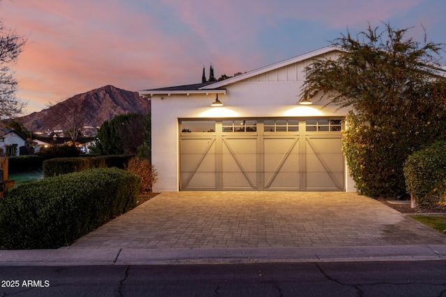 view of front of home with a garage and a mountain view