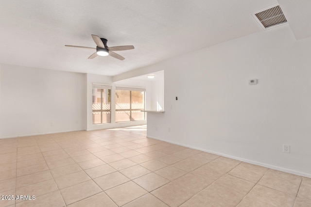 unfurnished room with baseboards, a ceiling fan, light tile patterned flooring, and visible vents