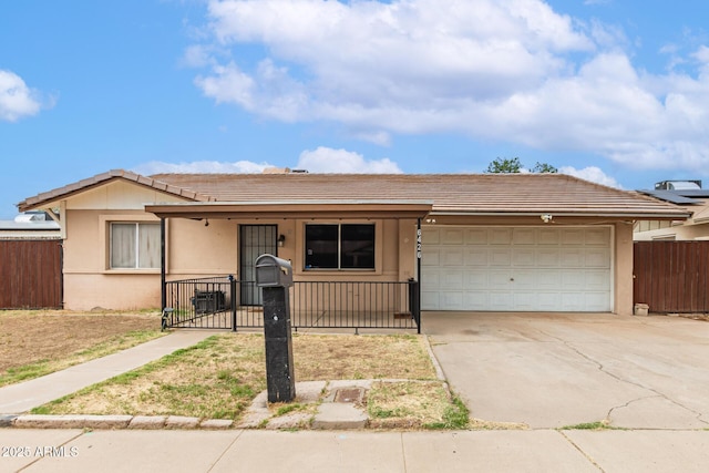 6426 W Lamar Rd, Glendale, AZ 85301 - single story home with a tile roof, an attached garage, concrete driveway, stucco siding, and a porch