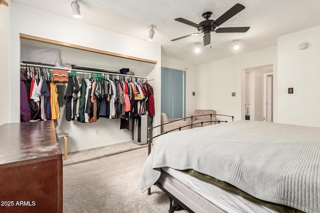 6426 W Lamar Rd, Glendale, AZ 85301 - bedroom with a closet, carpet flooring, ceiling fan, a textured ceiling, and baseboards