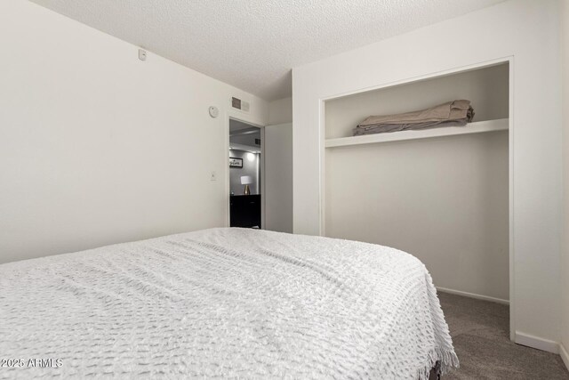 6426 W Lamar Rd, Glendale, AZ 85301 - bedroom with carpet, a textured ceiling, and a closet
