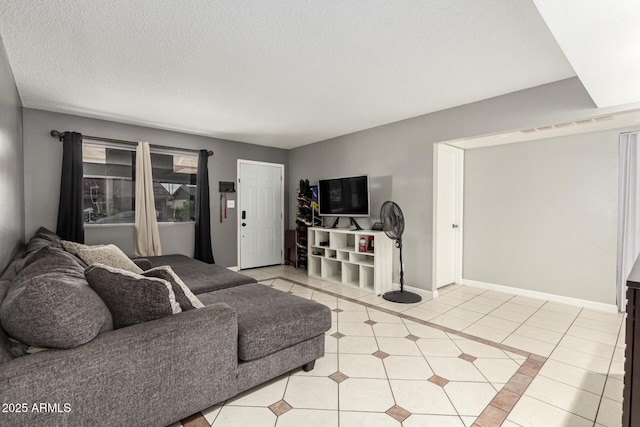 6426 W Lamar Rd, Glendale, AZ 85301 - living area featuring light tile patterned floors, baseboards, and a textured ceiling