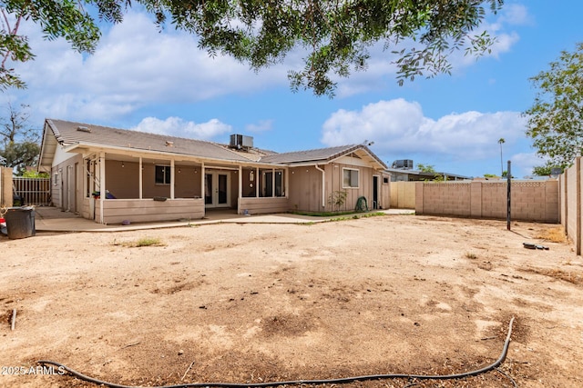 6426 W Lamar Rd, Glendale, AZ 85301 - back of property featuring french doors, a patio area, a fenced backyard, and board and batten siding