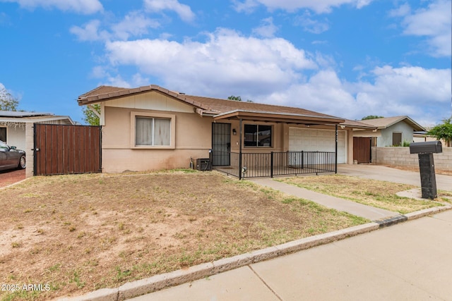 6426 W Lamar Rd, Glendale, AZ 85301 - ranch-style house with an attached garage, driveway, fence, stucco siding, and a gate