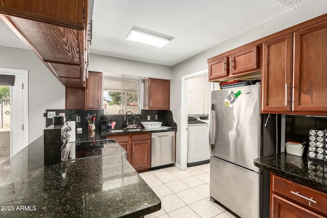6426 W Lamar Rd, Glendale, AZ 85301 - kitchen featuring stainless steel appliances, a sink, backsplash, dark stone countertops, and light tile patterned floors