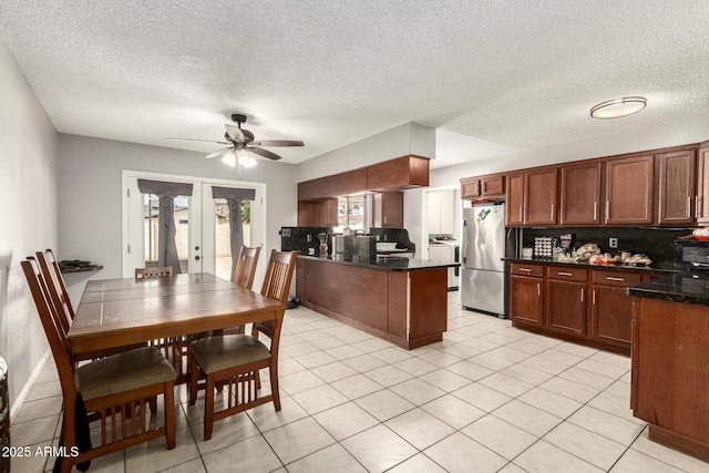 6426 W Lamar Rd, Glendale, AZ 85301 - kitchen featuring freestanding refrigerator, ceiling fan, a peninsula, french doors, and decorative backsplash