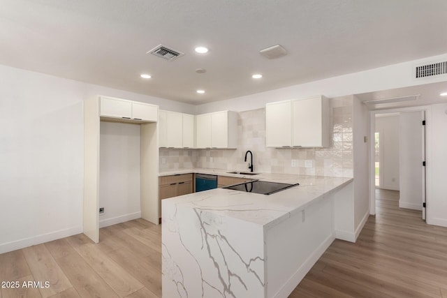 2443 E Randall Dr, Tempe, AZ 85288 - kitchen featuring a peninsula, a sink, light wood finished floors, light stone countertops, and recessed lighting