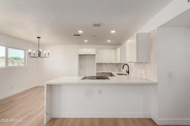 2443 E Randall Dr, Tempe, AZ 85288 - kitchen with a sink, a peninsula, tasteful backsplash, baseboards, and recessed lighting