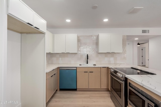 2443 E Randall Dr, Tempe, AZ 85288 - kitchen featuring a sink, appliances with stainless steel finishes, light wood finished floors, light stone counters, and decorative backsplash