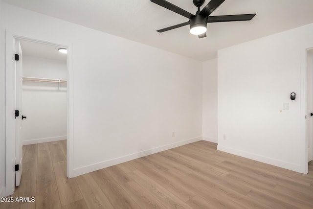 2443 E Randall Dr, Tempe, AZ 85288 - unfurnished bedroom featuring light wood finished floors, a closet, baseboards, a walk in closet, and a ceiling fan