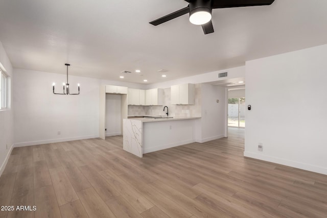 2443 E Randall Dr, Tempe, AZ 85288 - unfurnished living room featuring a chandelier, light wood-style floors, a ceiling fan, recessed lighting, and baseboards
