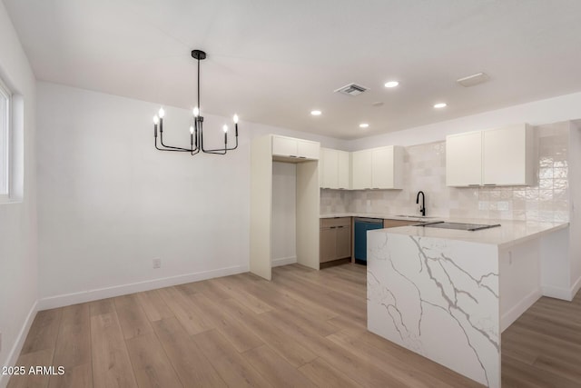 2443 E Randall Dr, Tempe, AZ 85288 - kitchen featuring a peninsula, dishwasher, light wood finished floors, decorative backsplash, and a chandelier