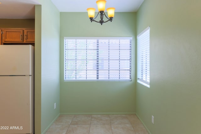 interior space featuring a chandelier and light tile patterned flooring